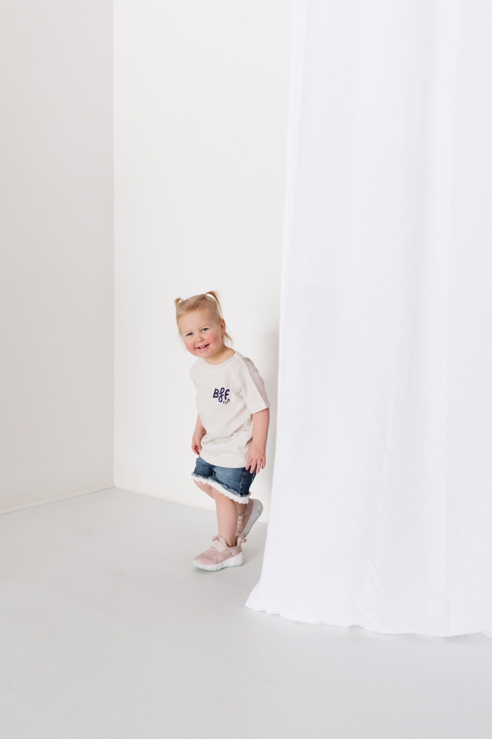 toddler smiling wearing gray shirt with bff club on it