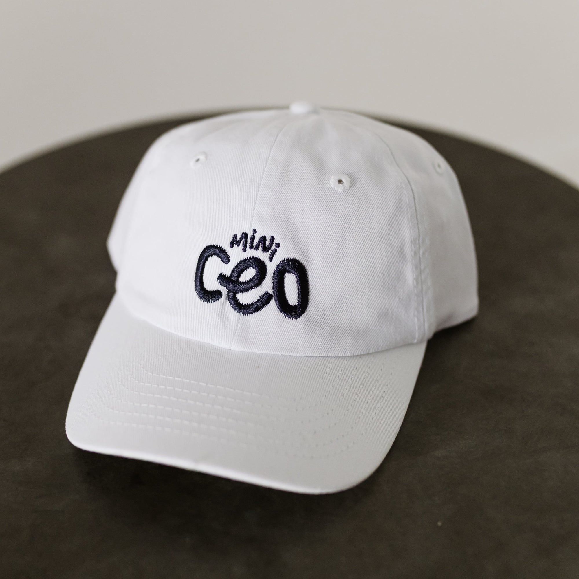white baseball hat with navy embroidery "mini ceo" for toddlers