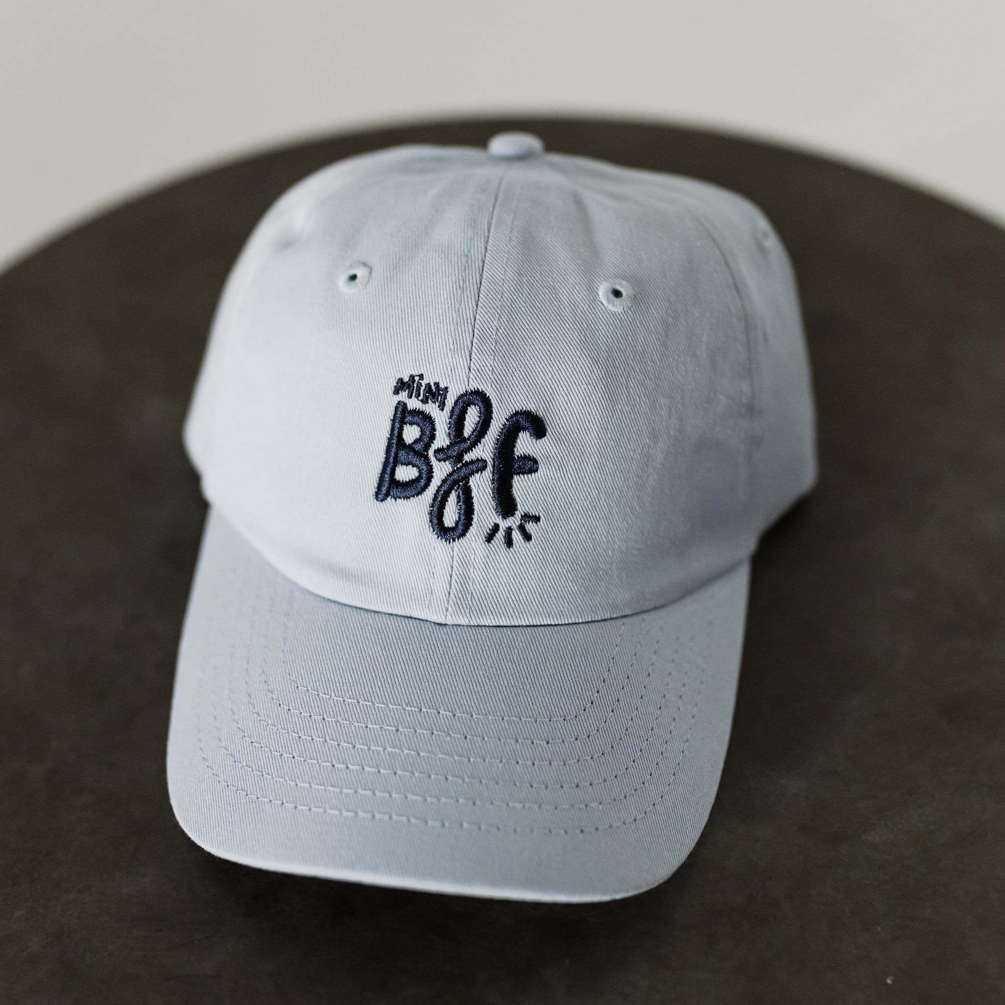 light blue baseball cap with navy embroidery saying mini bff