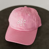 pink baseball cap with light pink embroidery saying mini bff