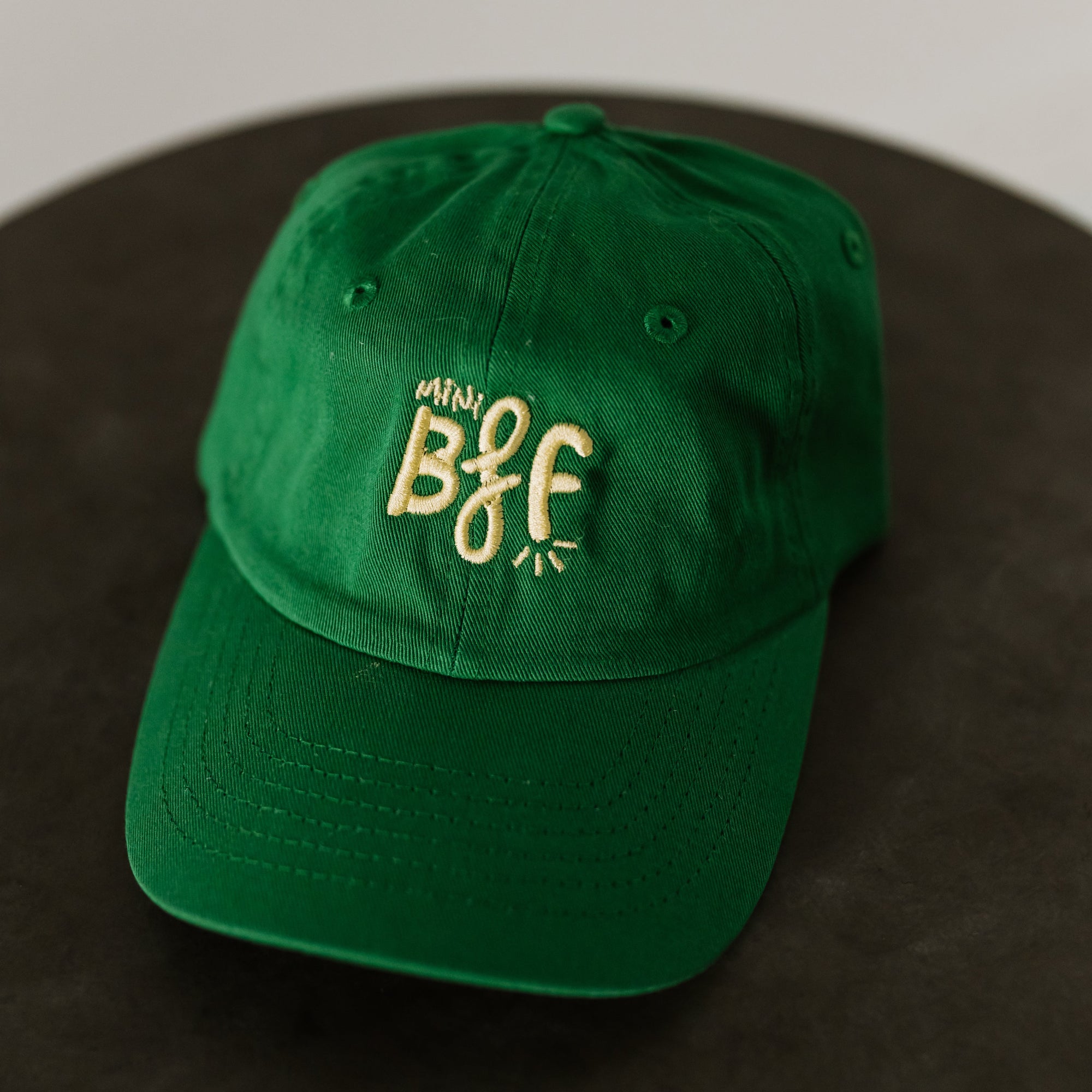 green baseball cap with light green embroidery saying mini bff
