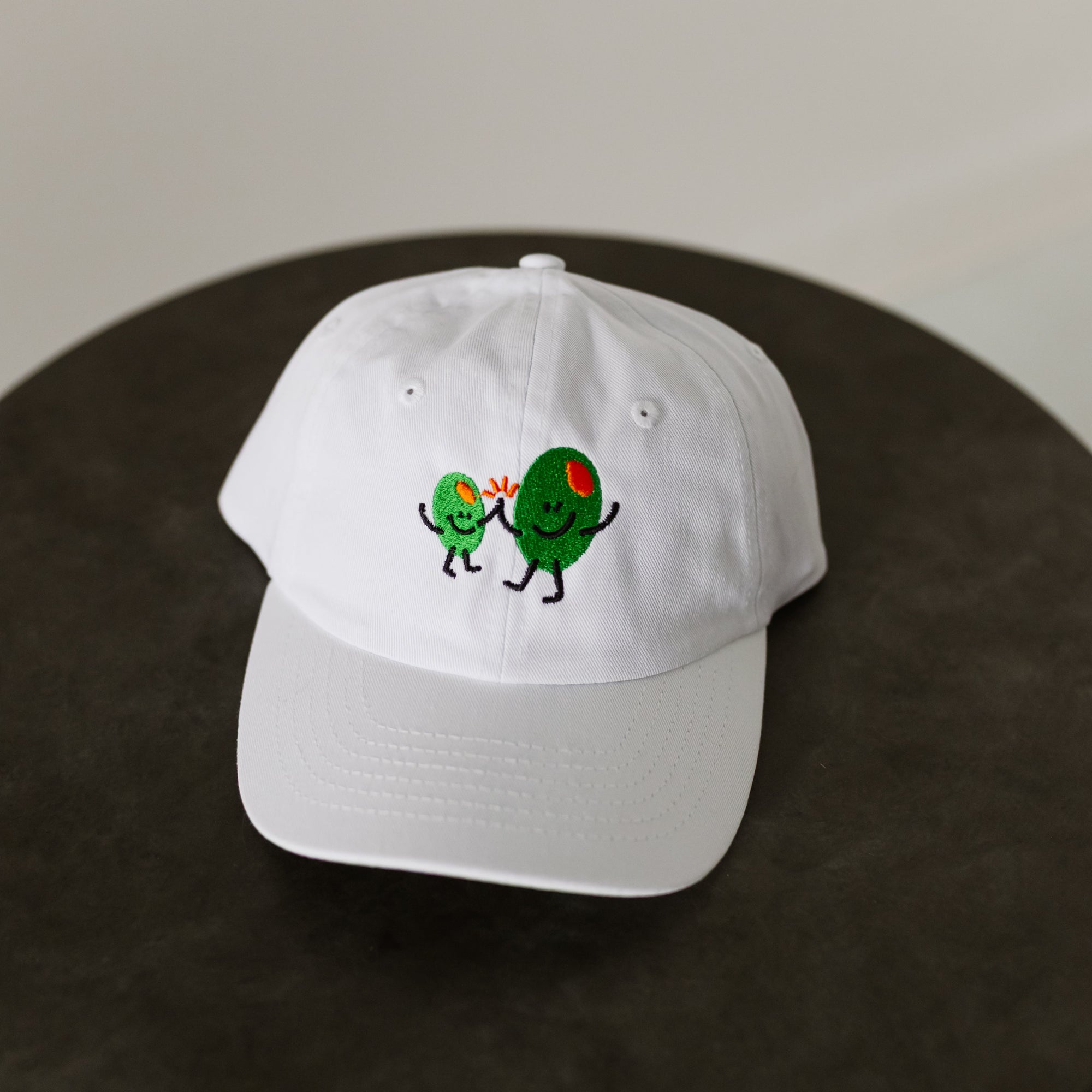 white baseball cap for toddler with multi-colored embroidery "Olive BFF's" on front of hat